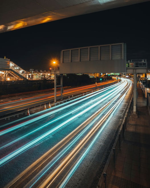 a long exposure photo of a highway at night