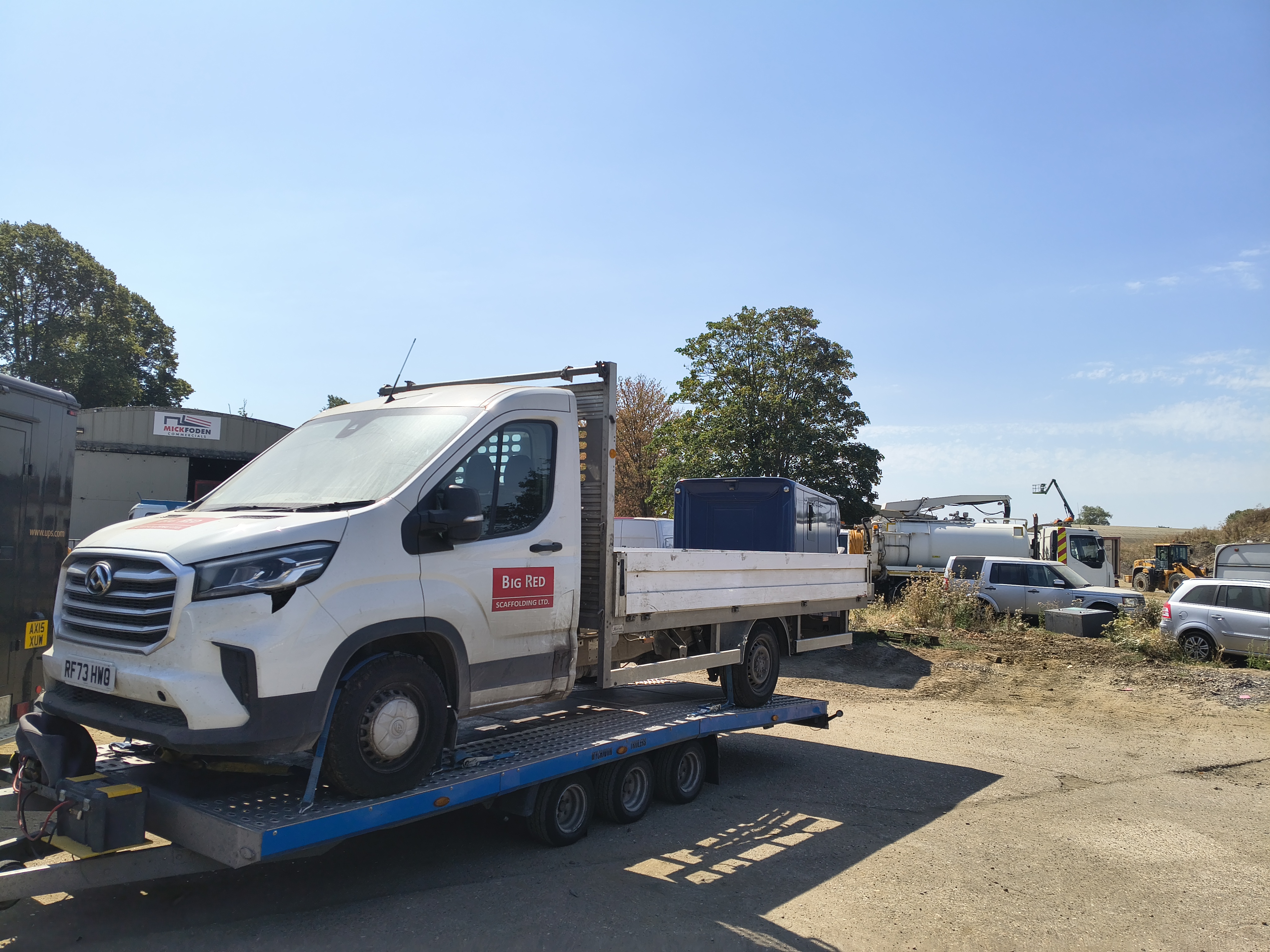 Commercial van secured on a recovery trailer